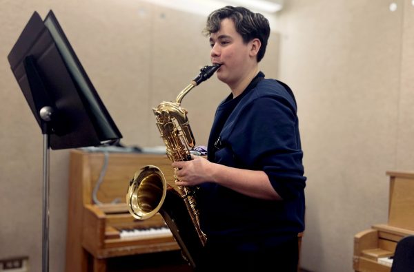 Practicing for upcoming performances, freshman Brendan McKellar plays The Sea Between on baritone saxophone. The FCHS Saxophone Quartet and Saxophone Trio will play on April 21 and 29.